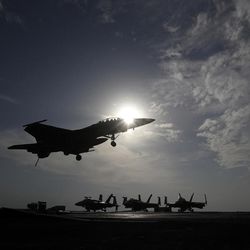 CORRECTS NAME OF SHIP - In this picture taken on Monday, Nov. 21, 2016, a U.S. Navy fighter jet lands on the deck of the U.S.S. Dwight D. Eisenhower aircraft carrier. The carrier is currently deployed in the Persian Gulf, supporting Operation Inherent Resolve, the military operation against Islamic State extremists in Syria and Iraq. 