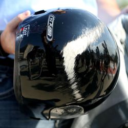 Nathan Christensen looks at the helmet he was wearing when he was in motorcycle accident two years ago during a press conference at Intermountain Medical Center in Murray on Wednesday, Aug. 2, 2017. Zero Fatalities, Intermountain Medical Center’s Level I Trauma Program and Harrison Eurosports are encouraging motorcycle riders to increase safety by wearing proper safety gear.