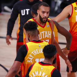 Utah Jazz’s Rudy Gobert (27) celebrates with teammates during a timeout during the second quarter of Game 3 of an NBA basketball first-round playoff series against the Denver Nuggets, Friday, Aug. 21, 2020, in Lake Buena Vista, Fla.