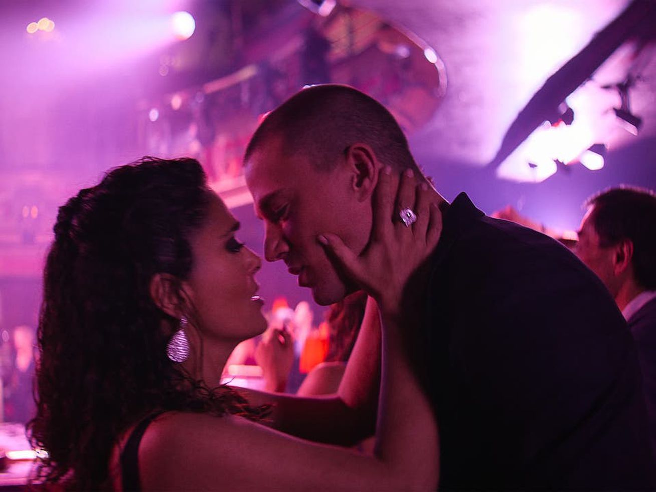 Salma Hayek Pinault and Channing Tatum go in for a kiss inside a nightclub.