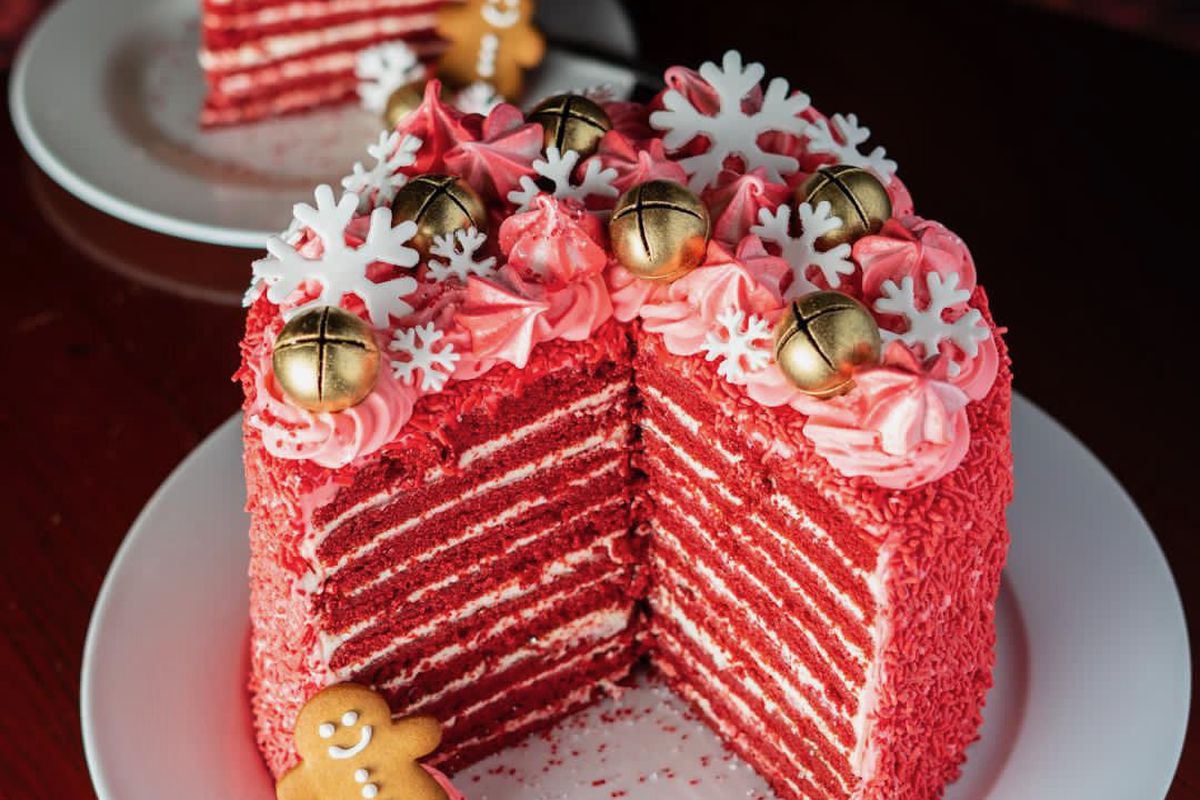 A 20-layer red velvet cake with snowflakes and bells on top