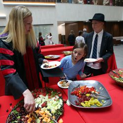 Kim Reeves dishes up food with daughter Brooke and son Hunter at a commencement reception at the University of Utah's S.J. Quinney College of Law in Salt Lake City on Friday, May 11, 2018.