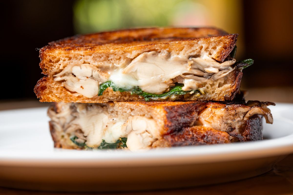 A close up side cut view of a mushroom and cheese grilled sandwich at modern diner Denae’s in Los Angeles.
