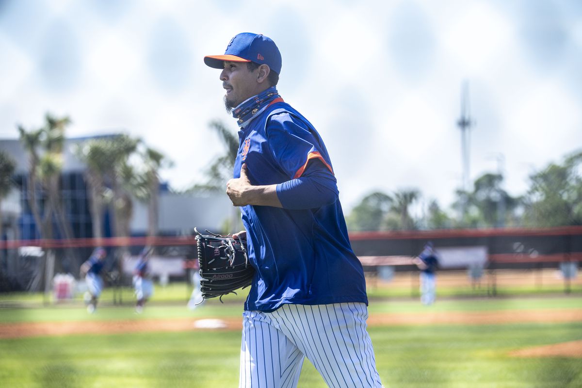 New York Mets pitcher Carlos Carrasco runs during a spring training drill in Port St. Lucie, Fla.