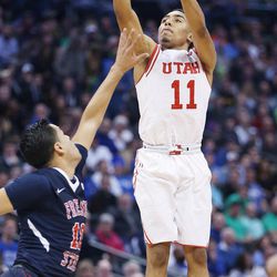 Utah Utes guard Brandon Taylor (11) shoots over Fresno State Bulldogs forward Cullen Russo (13) during the NCAA basketball tournament in Denver Thursday, March 17, 2016. Utah won 80-69. 