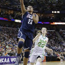 Connecticut forward Kaleena Mosqueda-Lewis (23) goes up for a shot against Notre Dame guard Madison Cable (22) in the first half of the women's NCAA Final Four college basketball tournament semifinal, Sunday, April 7, 2013, in New Orleans. 