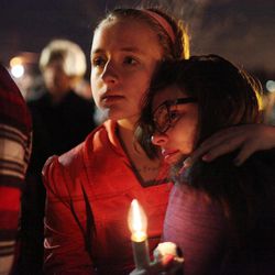 This Saturday, Jan. 3, 2015 photo shows Anne Neal, left, embracing Alysia Jones after they both spoke at the vigil at Kings Mills High School to remember the life of Leelah Alcorn, a 17 year-old transgender girl who committed suicide, in Kings Mills, Ohio.  In what's believed to be her final message, Alcorn implored: "My death needs to mean something." It has, at least making her a poignant new face for the transgender movement and those struggling to fit in. 