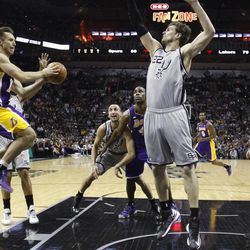 Los Angeles Lakers' Steve Nash, left, drives to the basket as San Antonio Spurs' Tiago Splitter (22), of Brazil, defends the goal during the second half of Game 2 of a first-round NBA basketball playoff series, Wednesday, April 24, 2013, in San Antonio, Texas. San Antonio won 102-91. (AP Photo/Eric Gay)