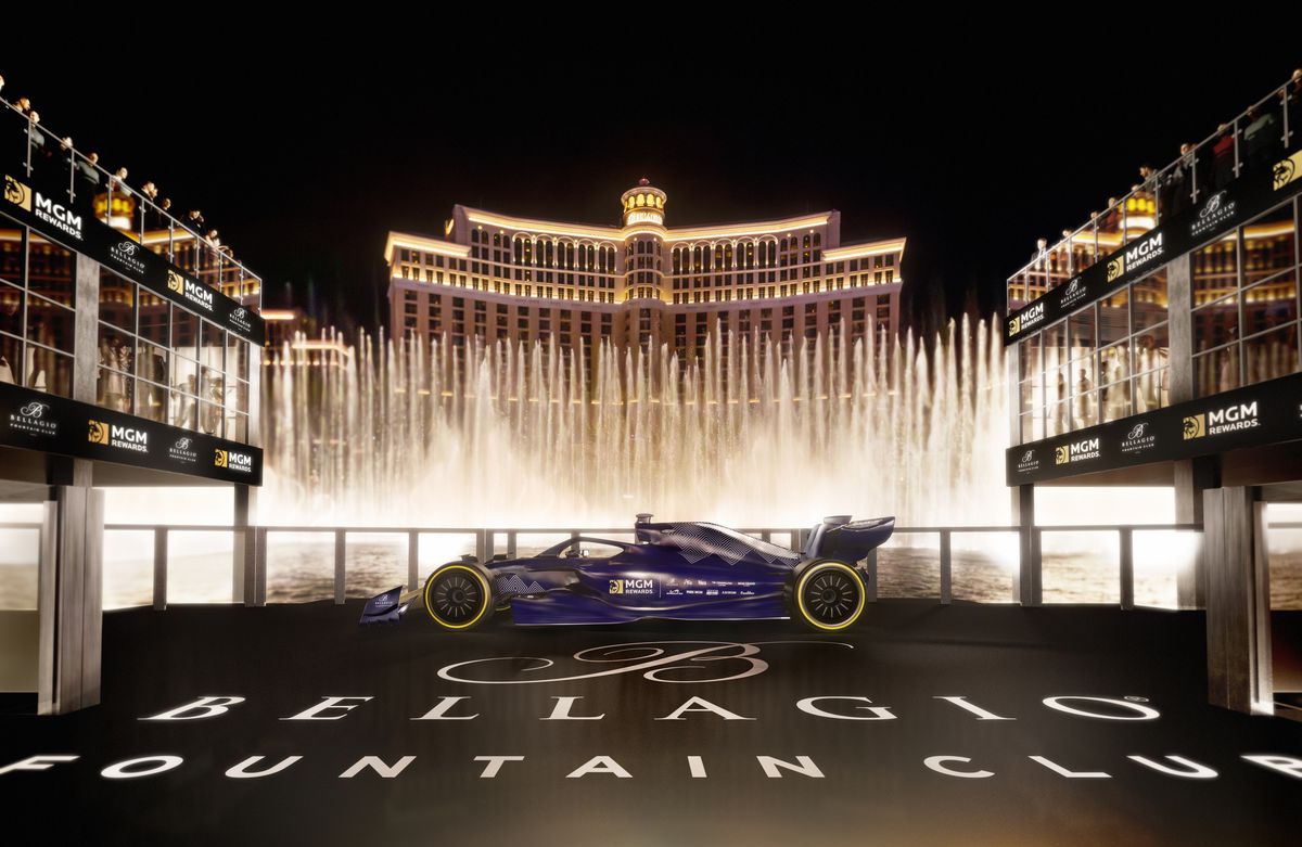 A racecar in front of the Bellagio Fountains.