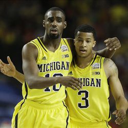 Michigan's Trey Burke, right, and Michigan's Tim Hardaway Jr. walk down the court during the second half of the NCAA Final Four tournament college basketball semifinal game against Syracuse, Saturday, April 6, 2013, in Atlanta. (AP Photo/Charlie Neibergall) 
