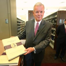 LDS Church Historian and Recorder Elder Steven E. Snow, shows a few of the pages of the new volume as the LDS Church, in cooperation with the Community of Christ announces the release of the printers manuscript of the the Book of Mormon, during a press conference Tuesday, Aug. 4, 2015, at the LDS Church's History library in Salt Lake City.