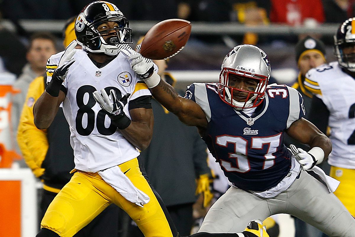 Alfonzo Dennard protects Emmanuel Sanders' hands from getting hit with the ball