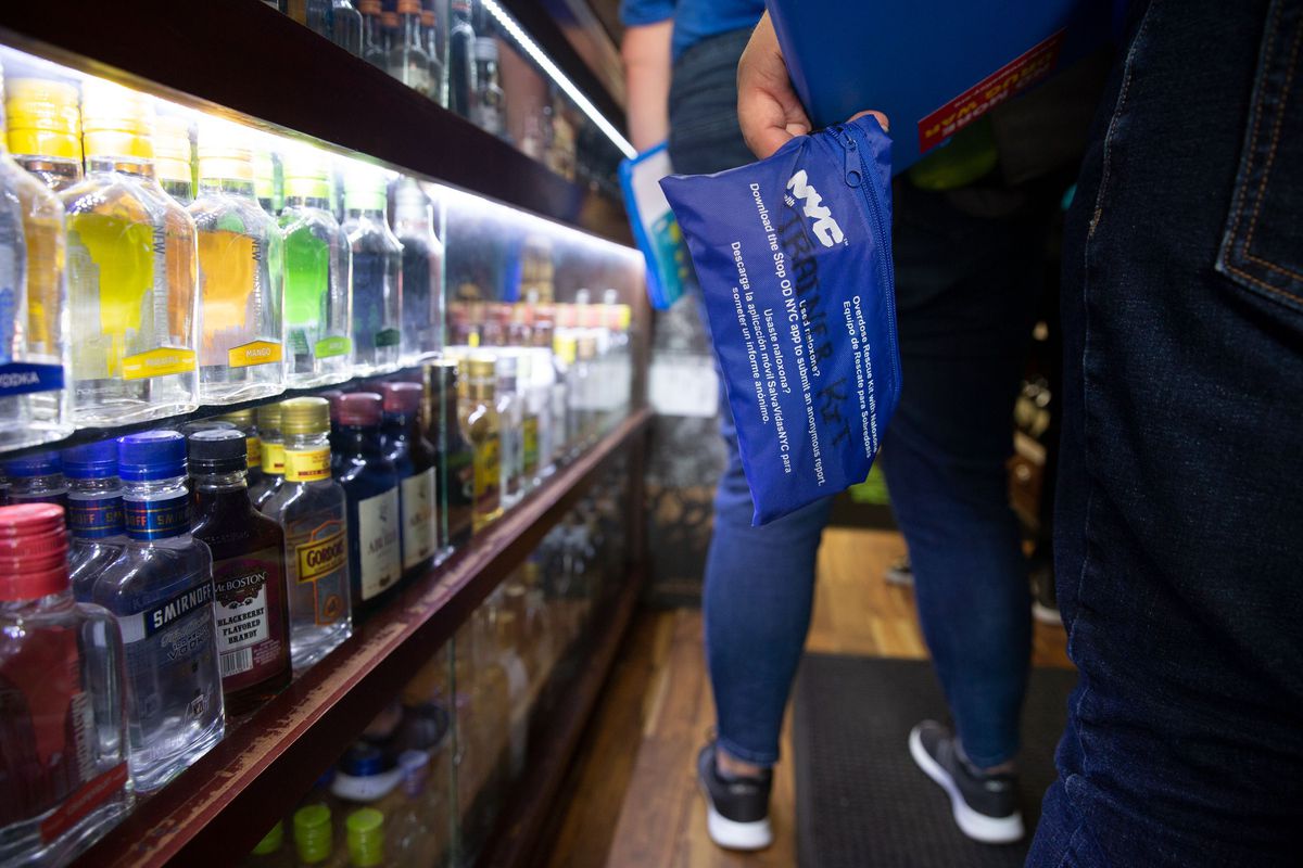 Health Department workers bring a opioid overdose treatment kit to a Washington Heights liquor store.