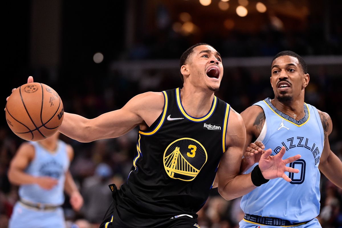 Jordan Poole #3 of the Golden State Warriors goes to the basket against De’Anthony Melton #0 of the Memphis Grizzlies during the first half at FedExForum on March 28, 2022 in Memphis, Tennessee