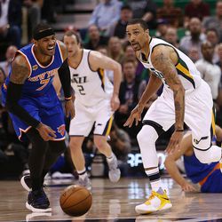 Utah Jazz guard George Hill (3 looks down court and fast break with New York Knicks forward Carmelo Anthony (7) reacting as the Utah Jazz and the New York Knicks play at Vivint Arena in Salt Lake City on Wednesday, March 22, 2017. The Jazz beat the Knicks 108-101.