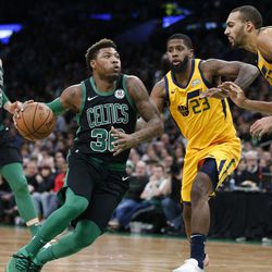 Boston Celtics' Marcus Smart (36) drives for the basket against Utah Jazz's Royce O'Neale (23) and Rudy Gobert (27) during the second half on an NBA basketball game in Boston, Saturday, Nov. 17, 2018. (AP Photo/Michael Dwyer)