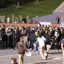 Protesters take the field after the game