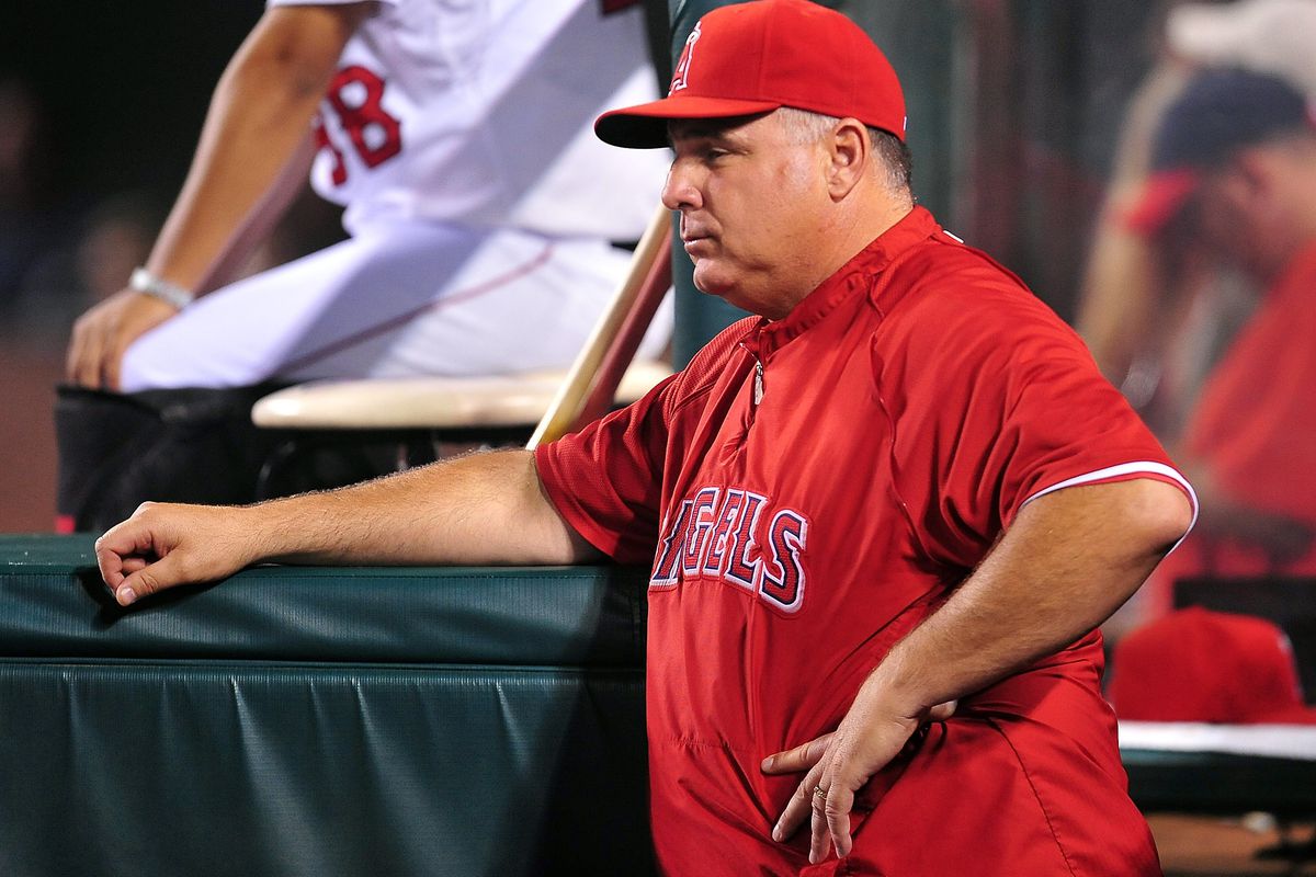 September 21, 2012; Anaheim, CA, USA; Los Angeles Angels manager Mike Scioscia (14) watches game action in the third inning against the Chicago White Sox at Angel Stadium. Mandatory Credit: Gary A. Vasquez-US PRESSWIRE