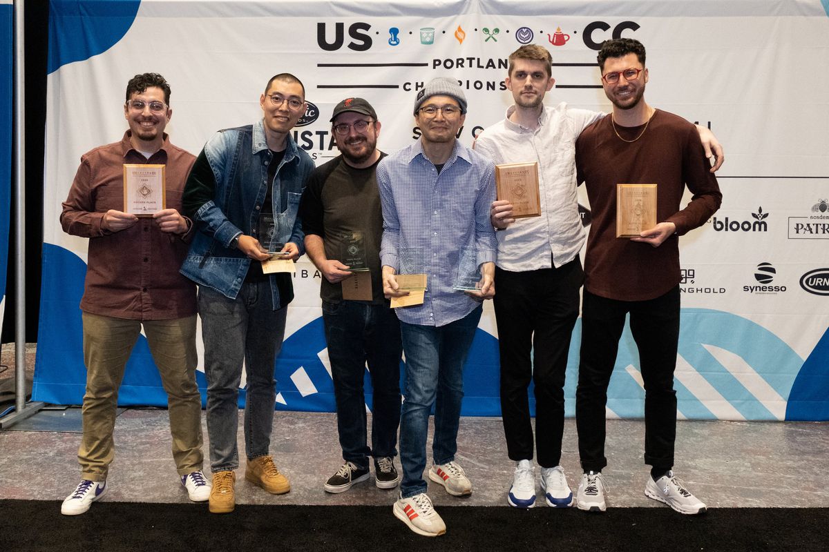 Six finalists in the Brewers Cup competition posing with their plaques.