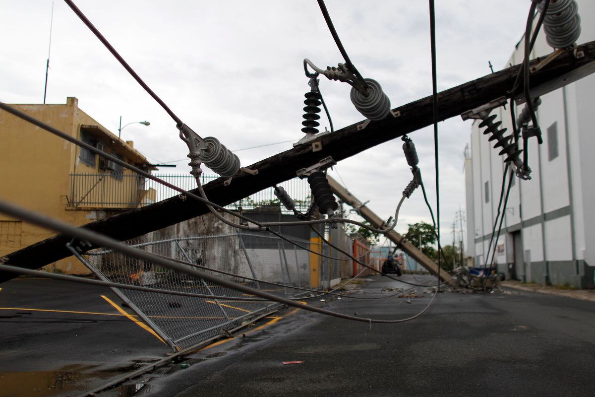 Power line poles downed by the passing of Hurricane Maria lie on a street in San Juan, Puerto Rico on November 7, 2017.