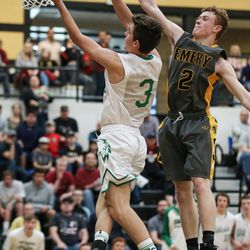South Summit's Jake Rydalch goes to the hoop ahead of Emery's Cade Brazier during a 3A boys basketball first round game at Wasatch High School in Heber City on Saturday, Feb. 17, 2018.