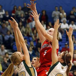 Springville's #5 Lexi Eaton (center) puts of a last second shot over Snow Canyon's #13 RileyPearce (left) and #3 Alexa Esplin giving her team a 56-55 win in the 4A basketball semifinals at Salt Lake Community College.  Friday, Feb. 26, 2010. Photo by Scott G Winterton Deseret News.