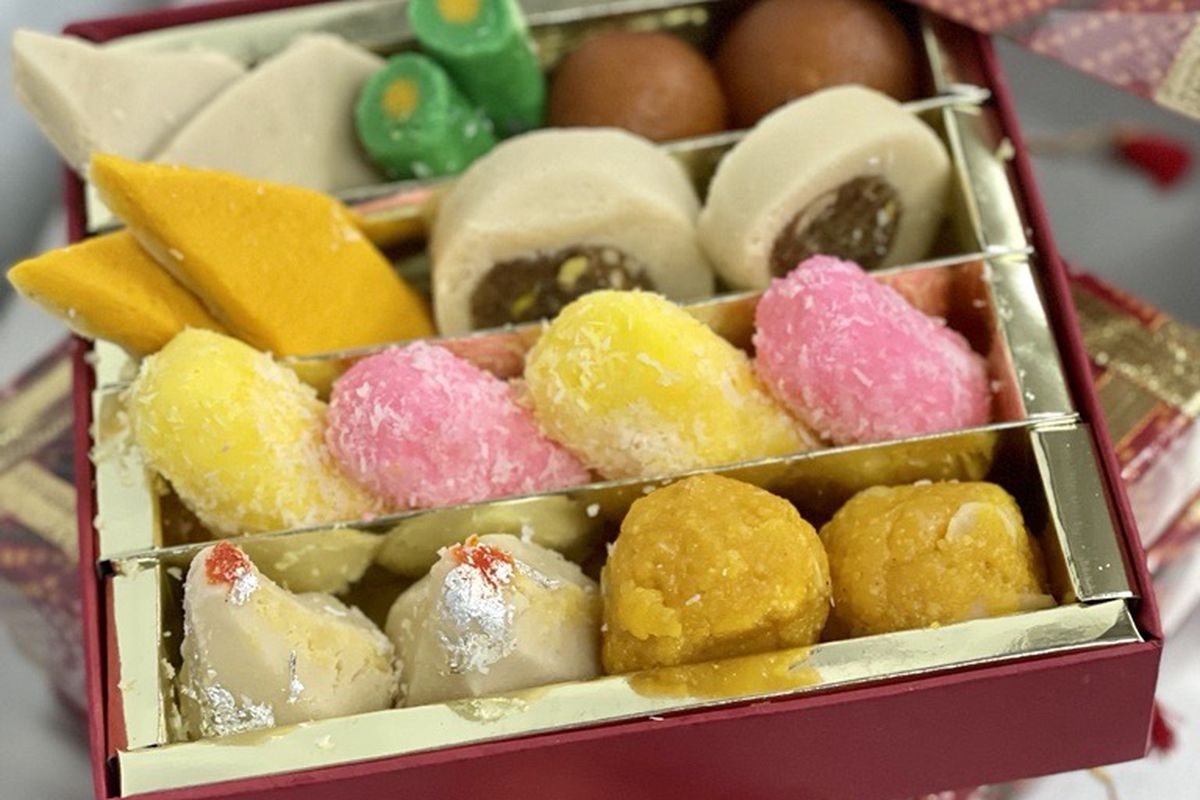 A box of colorful, bite-sized confections with the lid propped off to one side.
