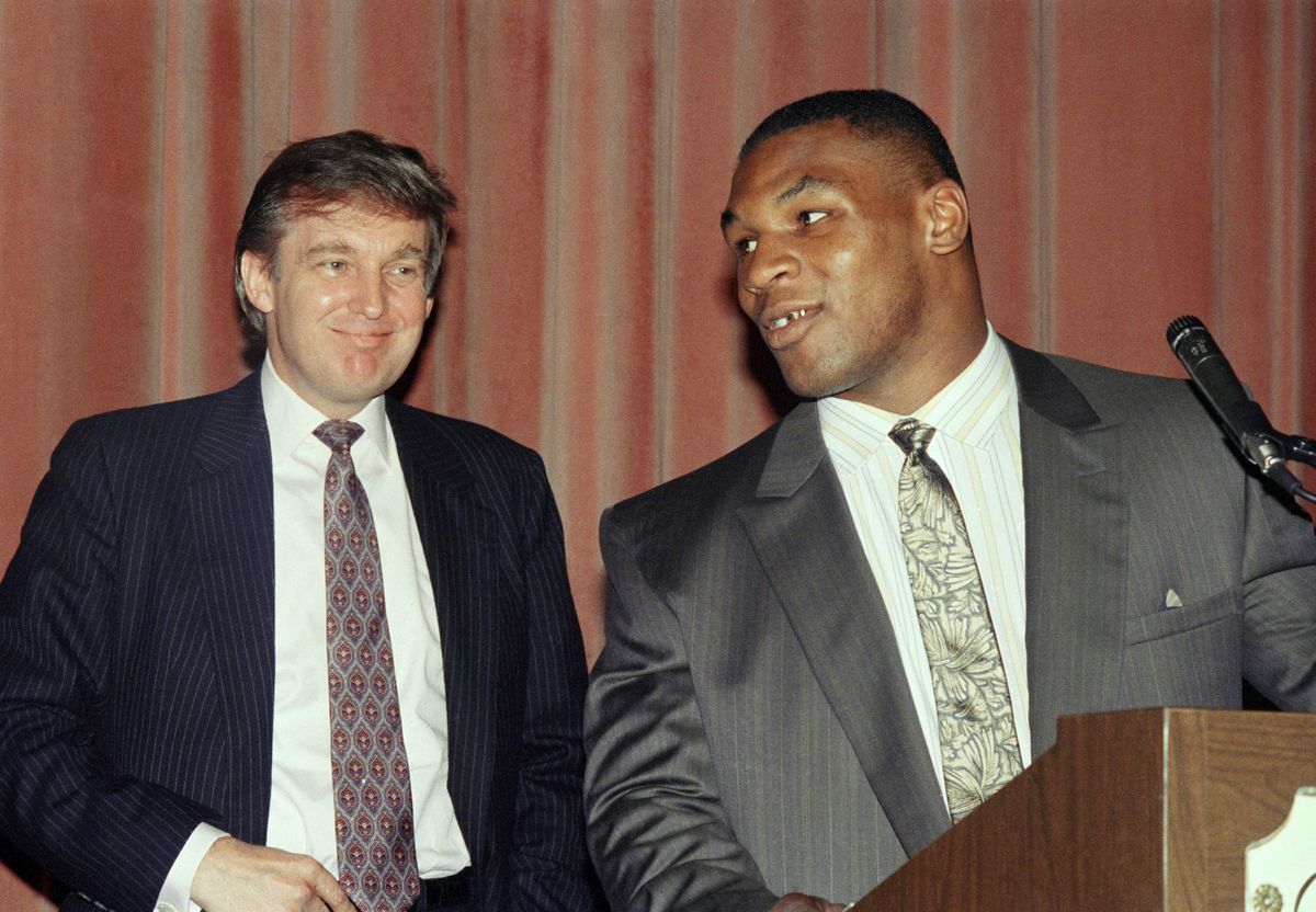 FILE - Heavyweight champion Mike Tyson, right, speak at a news conference while advisor Donald Trump looks in New York, Tuesday, July 27, 1988 after announcing a settlement between Tyson and his manager, Bill Cayton. Tyson, who had sued to break his contr