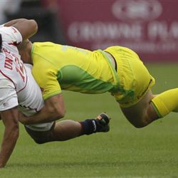 United States player Maka Unufe, left, is tackled by Australia's Cameron Clark during the fist day of Emirates Airline Dubai Rugby Sevens in Dubai, United Arab Emirates, Friday Nov. 30, 2012. 