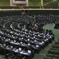This photo taken on Sunday, Feb. 19, 2017, shows an open session of the Iranian parliament in Tehran, Iran. Iran's parliament voted overwhelmingly Sunday to increase spending on its ballistic missile program and the foreign operations of its paramilitary Revolutionary Guard, chanting "Death to America" in a direct challenge to Washington's newest sanctions on the Islamic Republic. (AP Photo/Vahid Salemi)