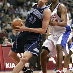 Utah Jazz forward Andrei Kirilenko (47), of Russia, drives to the basket while defended by Los Angeles Clippers forward Marcus Camby, right, in the first half of an NBA basketball game in Los Angeles, Tuesday.