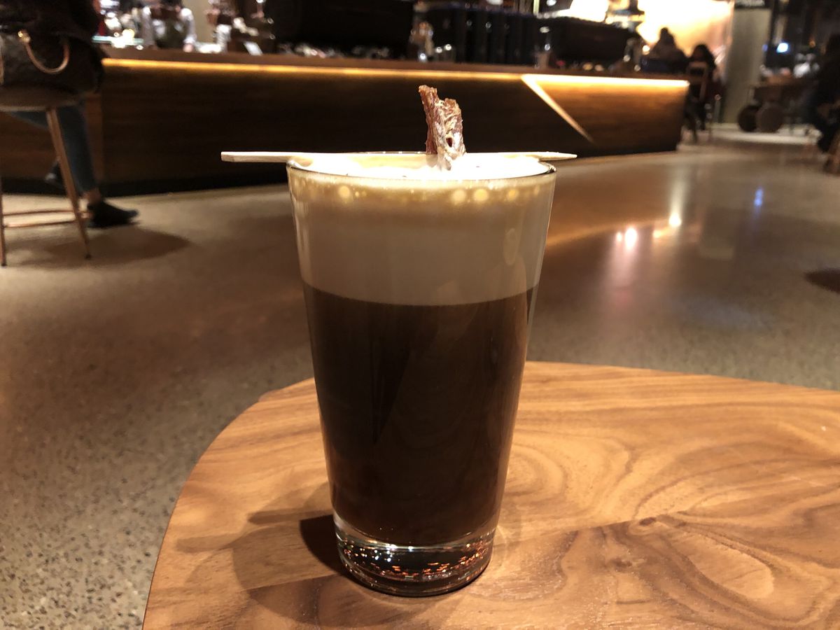 Nitro cold brew with peppercorn foam and beef jerky