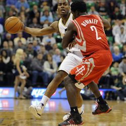 Utah Jazz point guard Alec Burks (10) passes around the defense of Houston Rockets point guard Patrick Beverley (2) during a game at EnergySolutions Arena on Monday, Dec. 2, 2013.