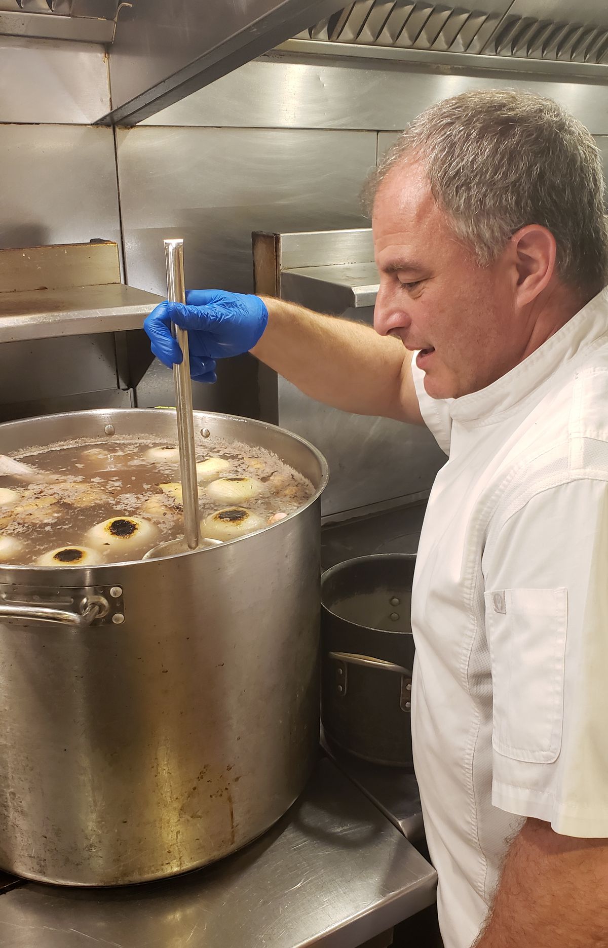 Chef Jon Krinn tends to a pot of pho