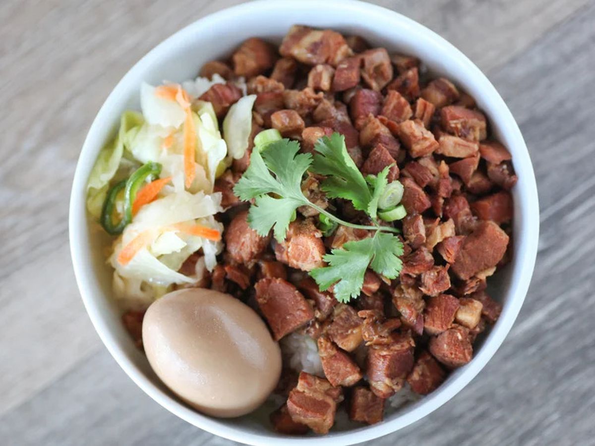 A bowl of ground meat, a soft-boiled egg, and rice.