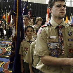Scout Robert Long, right, waits in the foyer of the Grand Ballroom at the Salt Palace on Thursday before the posting of the colors from hundreds of troops at a celebration of the 100th birthday of Boy Scouts of America. 