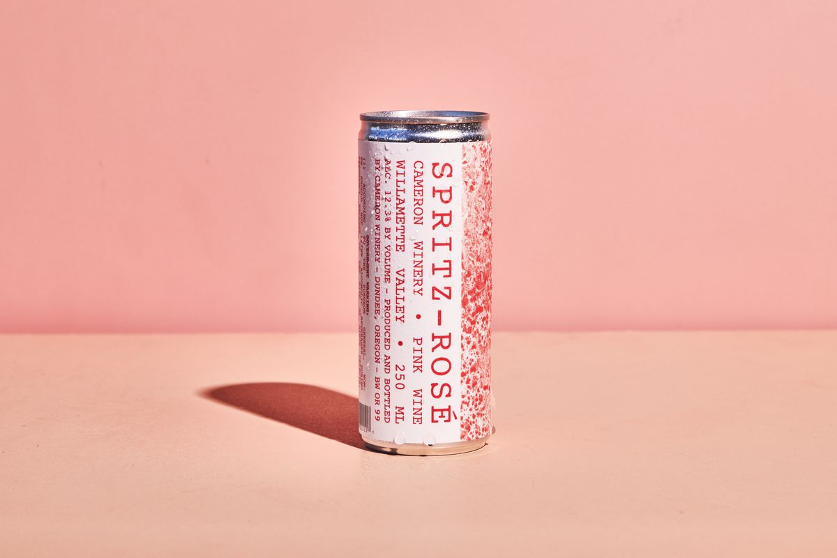 Aluminum can with pink lettering on the side that says 