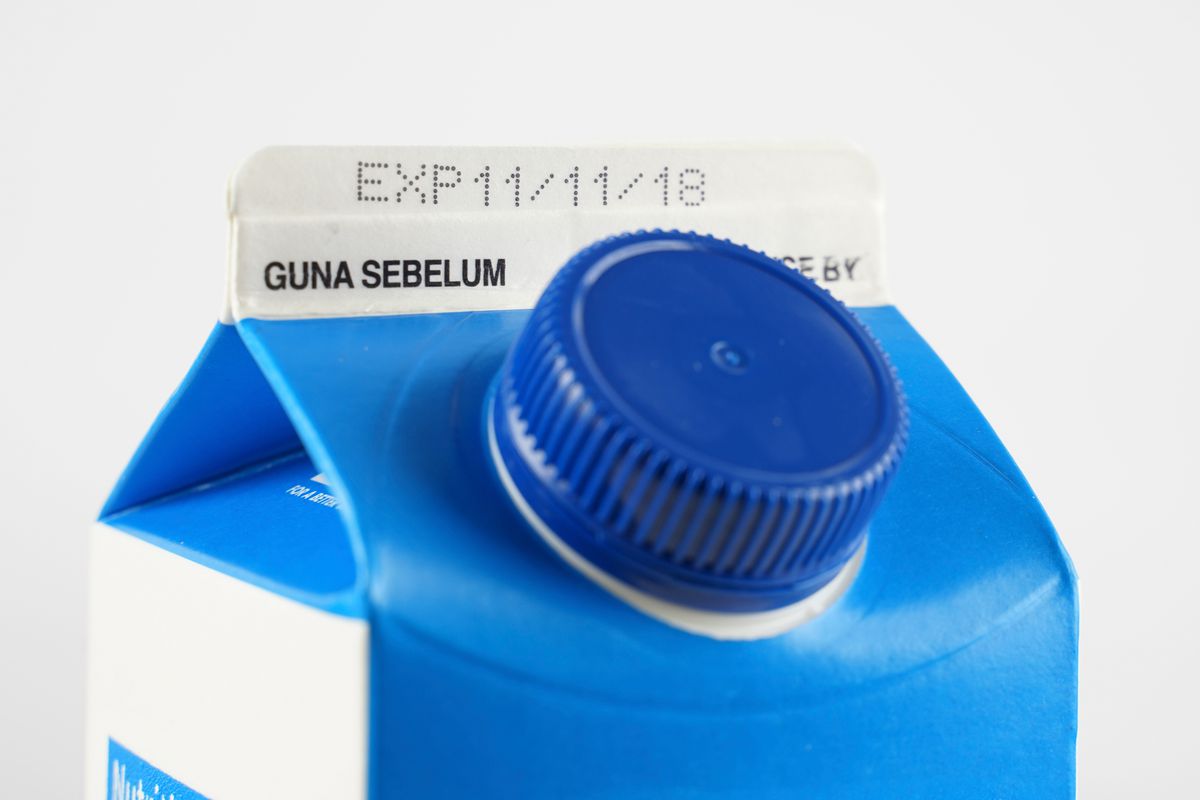 A milk carton with a sell-by date