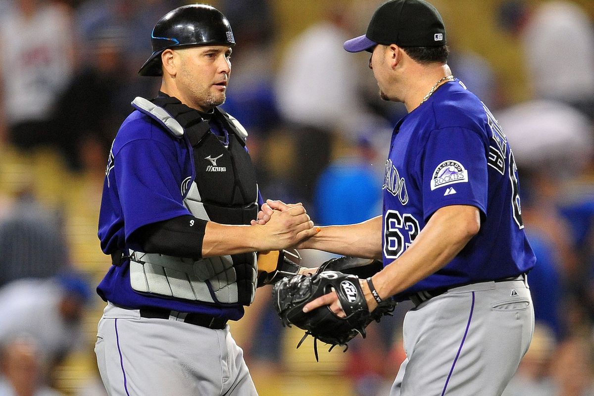 May 20, 2012; Los Angeles, CA, USA; Colorado Rockies catcher Ramon Hernandez (55) and relief pitcher Rafael Betancourt (63) celebrate their 3-1 victory against the Los Angeles Dodgers at Dodger Stadium.  Mandatory Credit: Gary A. Vasquez-US PRESSWIRE