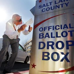 Craig Wessman places his ballot in a drop box at the Salt Lake County Government Center in Salt Lake City on Monday, Nov. 7, 2016.