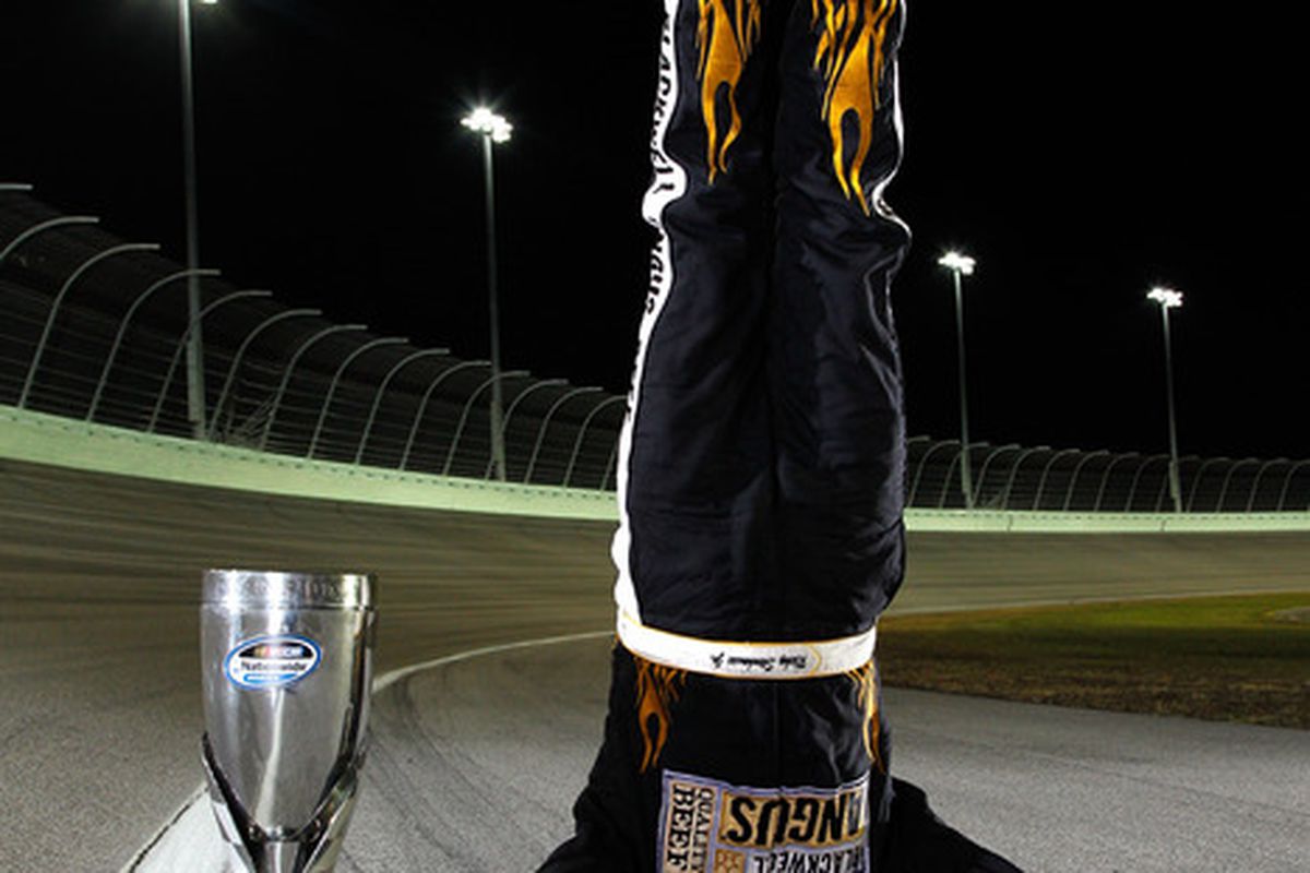 Ricky Stenhouse Jr. does a handstand next to the championship trophy after winning the 2011 NASCAR Nationwide Series championship at Homestead-Miami Speedway on Nov. 19.