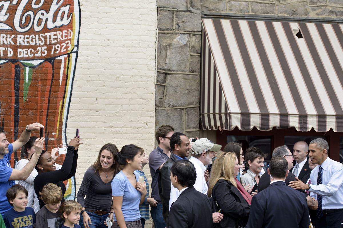 President Barack Obama greets the crowd at Manuel's Tavern.