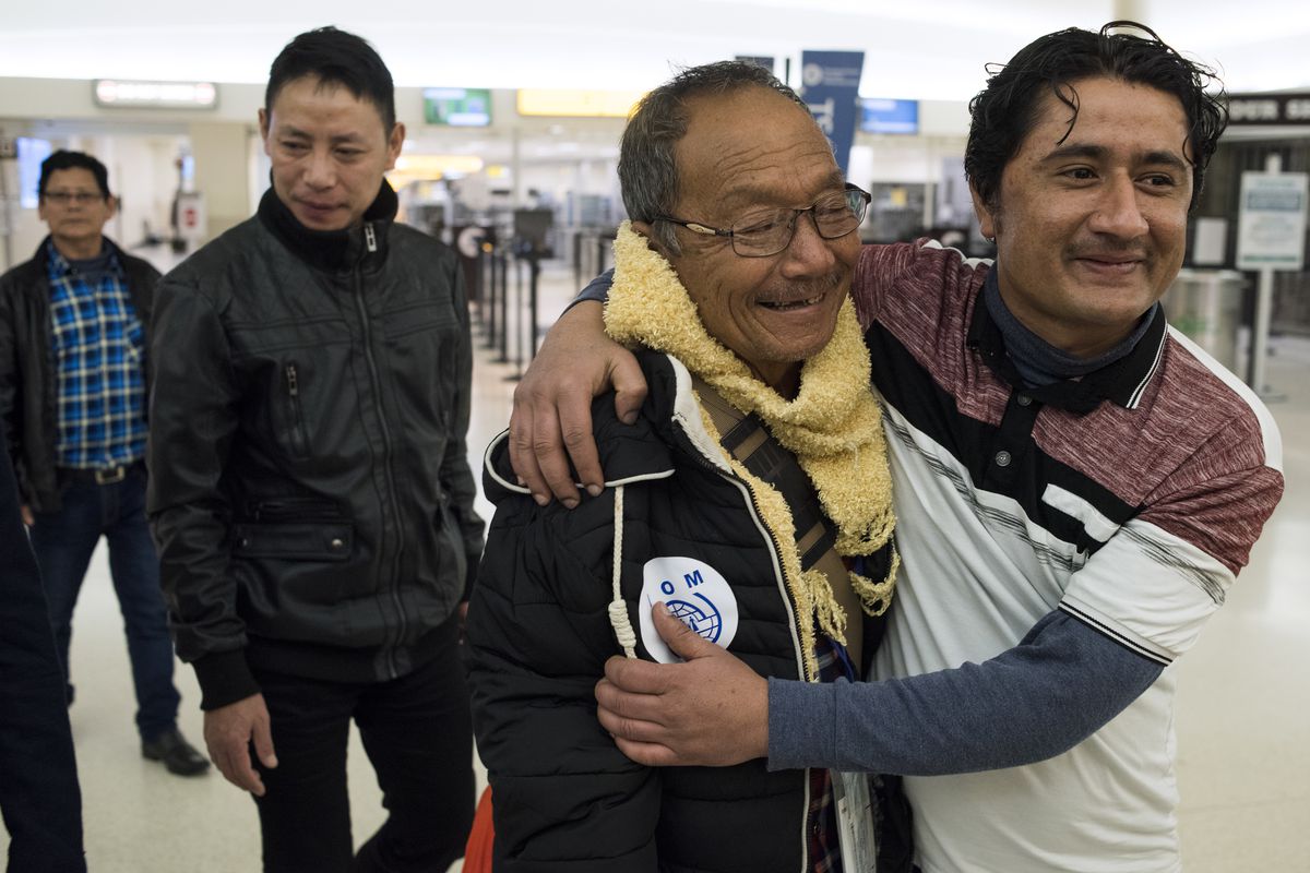 Kamal Sharma, right, of Columbus, embraces his relative Til Gurung, a Bhutanese refugee from Nepal, as he and other relatives arrive at the John Glenn Columbus International Airport in Columbus, Ohio on Thursday, Feb. 15, 2018. Two families of Bhutanese r