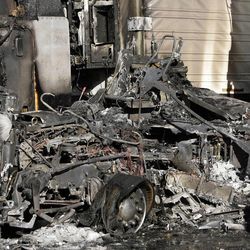 Police investigate trucks that caught fire at 3993 S. 300 West in Salt Lake City shortly before 6 a.m. Sunday, April 14, 2013.