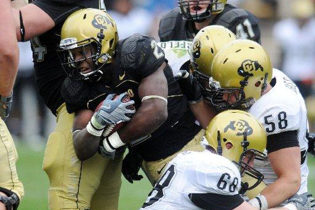 Darrell Scott fights for yards in the CU Spring game on Saturday. Photo: Cliff Grassmick