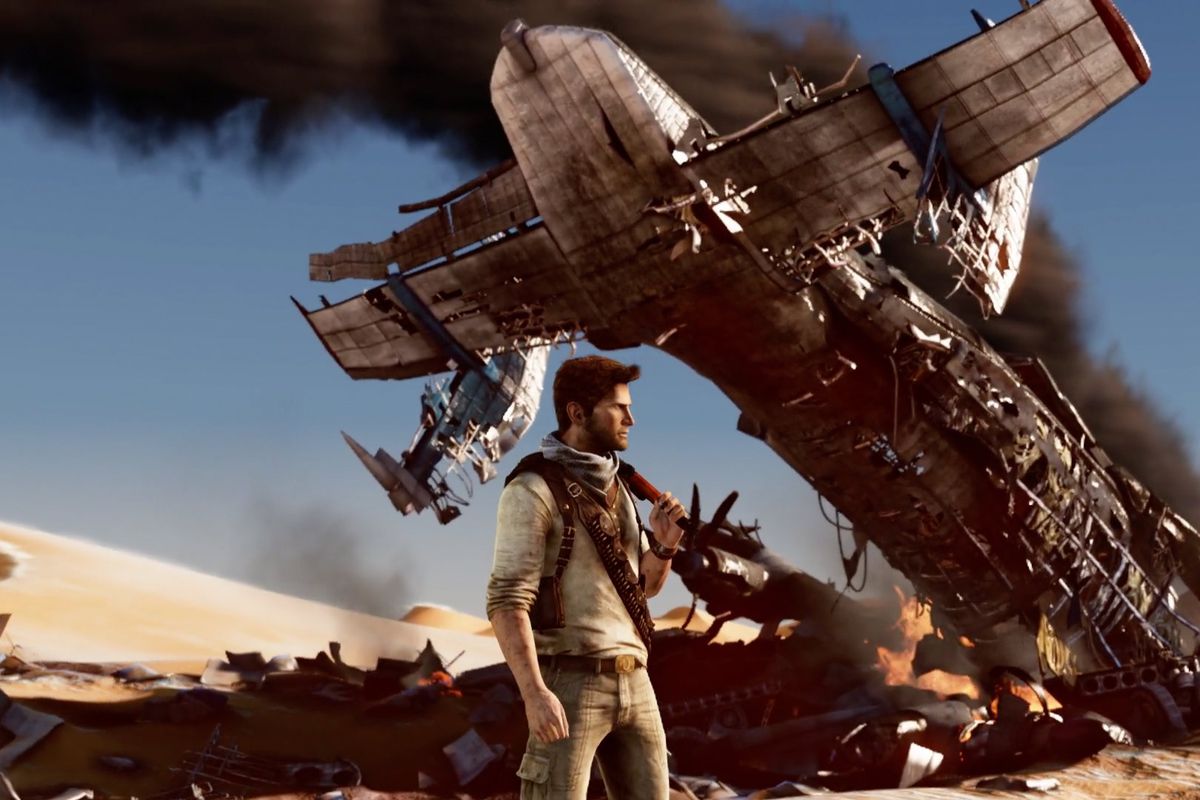 Nathan Drake stands in front of plane wreckage in a screenshot from Uncharted: The Nathan Drake Collection