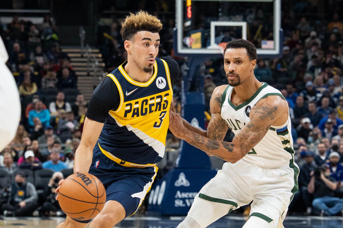 Indiana Pacers guard Chris Duarte (3) dribbles the ball while Milwaukee Bucks guard George Hill (3) defends in the first half at Gainbridge Fieldhouse.