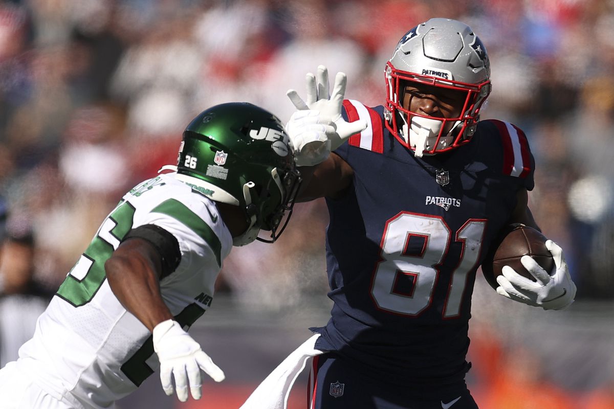 Jonnu Smith #81 of the New England Patriots looks to avoid a tackle after a catch during the first quarter against the New York Jets at Gillette Stadium on October 24, 2021 in Foxborough, Massachusetts.