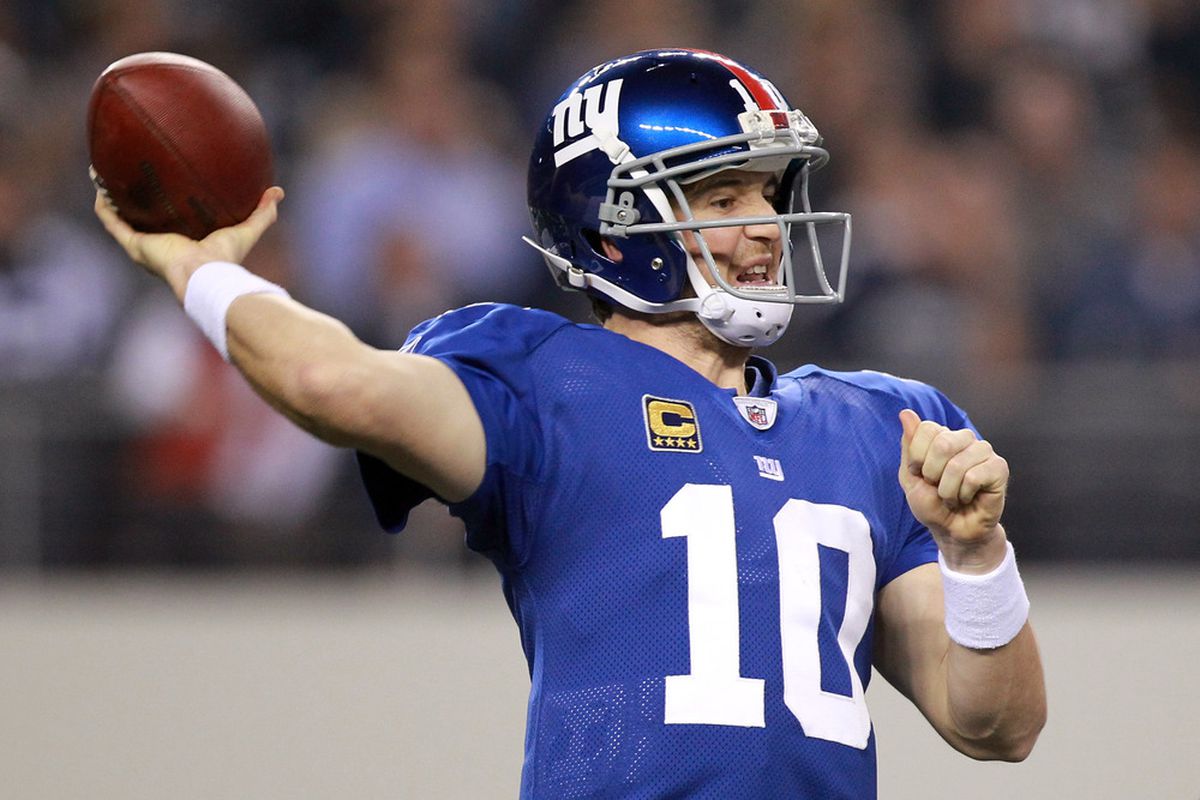 Quarterback Eli Manning of the New York Giants passes the ball in the second quarter against the Dallas Cowboys at Cowboys Stadium on December 11, 2011 in Arlington, Texas.  (Photo by Ronald Martinez/Getty Images)