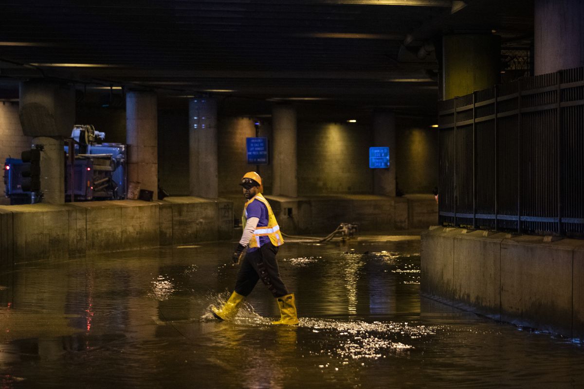 City workers remove water from Lower Wacker Drive near Randolph Street Monday morning after overnight flooding.